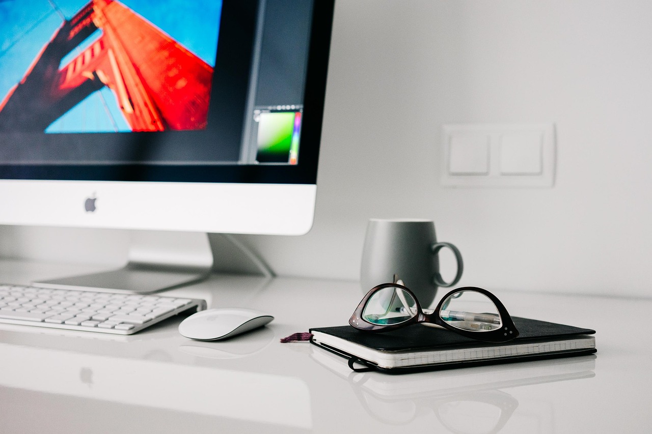 Modern email marketing workspace with laptop, coffee, and automation tools